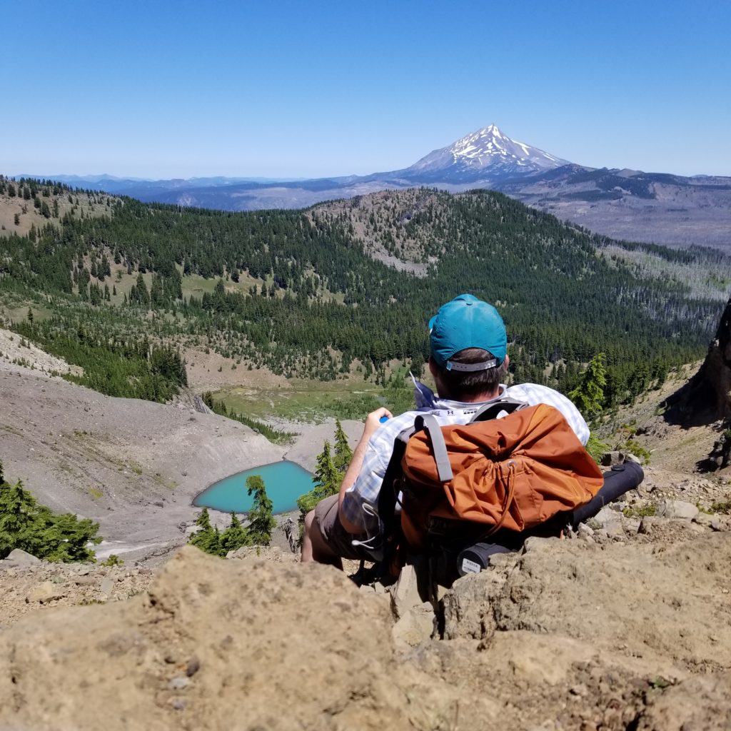 Backpacker looking across moraine landscape at Mt. Jefferson, thinking about WordPress Website Design near Bend, Oregon