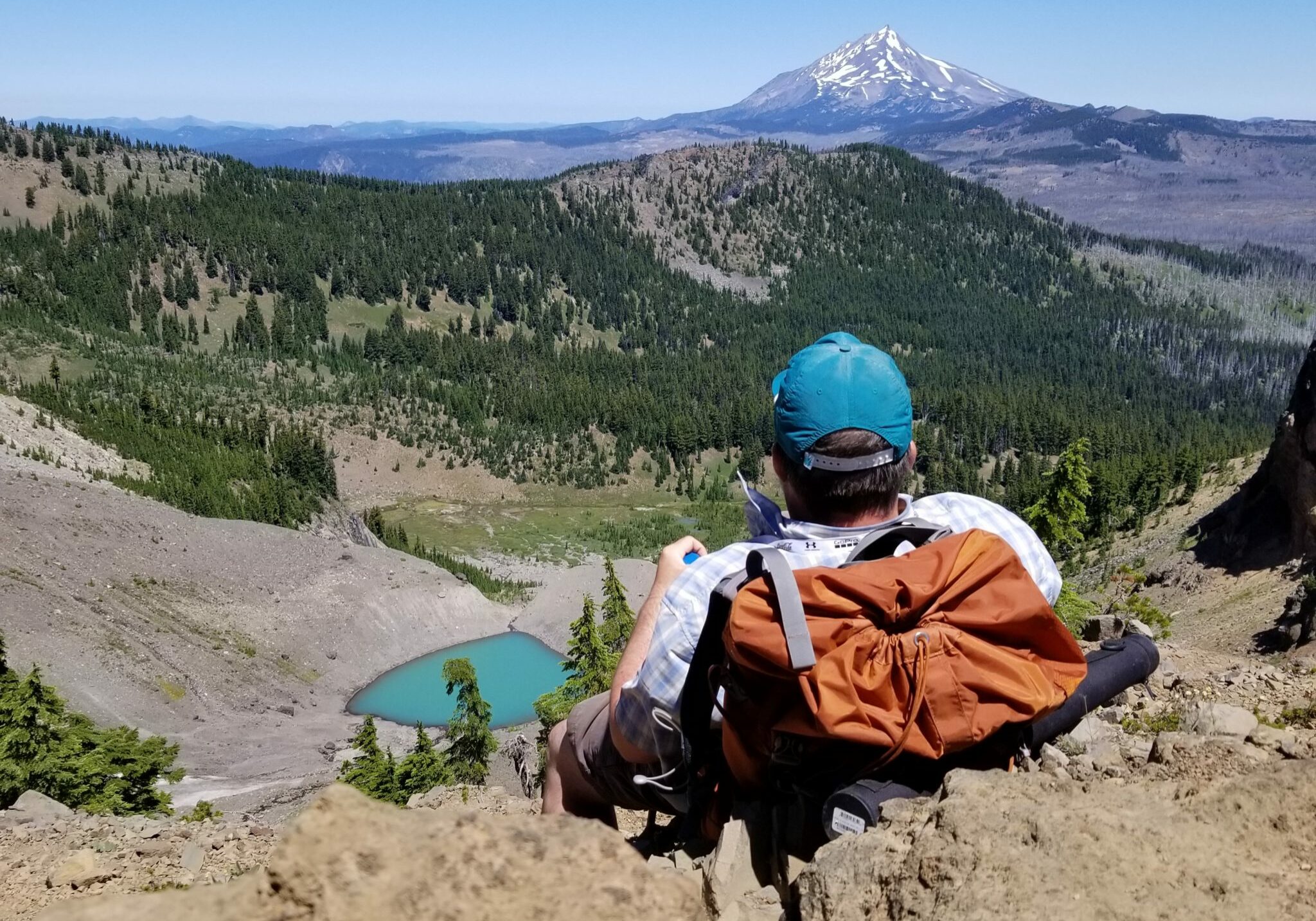 Backpacker looking across moraine landscape at Mt. Jefferson, thinking about WordPress Website Design near Bend, Oregon